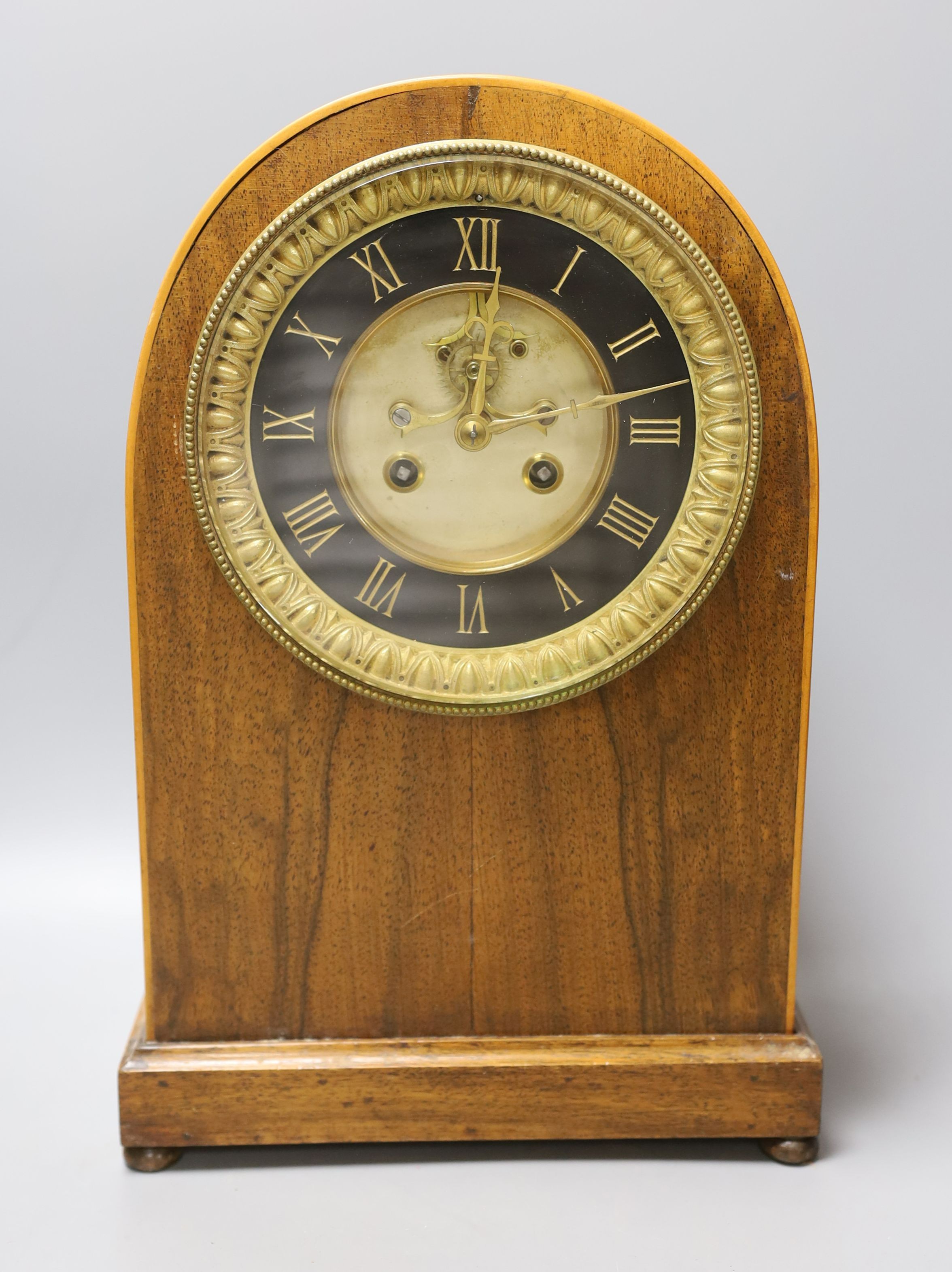 A late Victorian walnut mantel clock, French movement with pendulum, 35cm